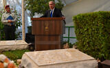 Prime Minister Benjamin Netanyahu speaks at a memorial event for his brother Yoni, in front of Yoni's grave (foreground) at the Mount Herzl military cemetery in Jerusalem, June 25, 2023. (Kobi Gideon/GPO)