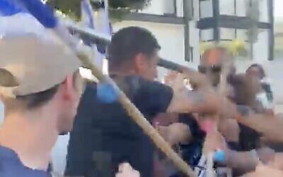 A screenshot from video of a man attacking anti-government protesters near Likud MK Shalom Danino's home in the southern town of Omer, July 7, 2023. (Twitter. Used in accordance with Clause 27a of the Copyright Law)