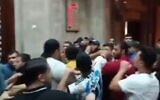 Worshippers struggle with Hamas policeman at the Al Awda mosque, a PIJ stronghold, in Rafah, Gaza, July 18, 2023. (Twitter video screenshot: used in accordance with Clause 27a of the Copyright Law)