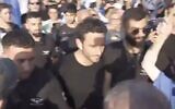 Police escort Channel 12 news reporter Gilad Shalmor during a pro-overhaul rally in Tel Aviv, July 23, 2024. (Twitter. Used in accordance with Clause 27a of the Copyright Law)