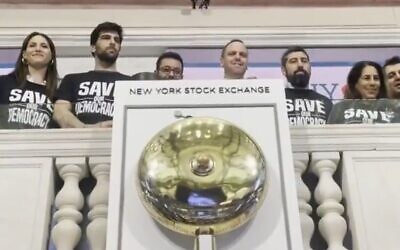Israeli tech CEOs and founders ring the opening bell at the New York Stock Exchange wearing 'Save our democracy' t-shirts, July 26, 2023. (i24news screenshot: used in accordance with Clause 27a of the Copyright Law)