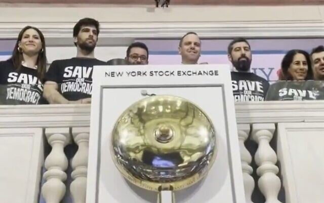 Israeli tech CEOs and founders ring the opening bell at the New York Stock Exchange wearing 'Save our democracy' t-shirts, July 26, 2023. (i24news screenshot: used in accordance with Clause 27a of the Copyright Law) Israeli tech CEOs and founders ring the opening bell at the New York Stock Exchange wearing 'Save our democracy' t-shirts, July 26, 2023. (i24news screenshot: used in accordance with Clause 27a of the Copyright Law)