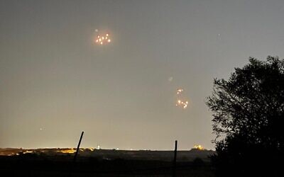 Illustrative: Shrapnel rains down over southern Israel, near the city of Sderot, after five rockets launched from the Gaza Strip are intercepted by the Iron Dome air defense system, July 5, 2023. (Courtesy)