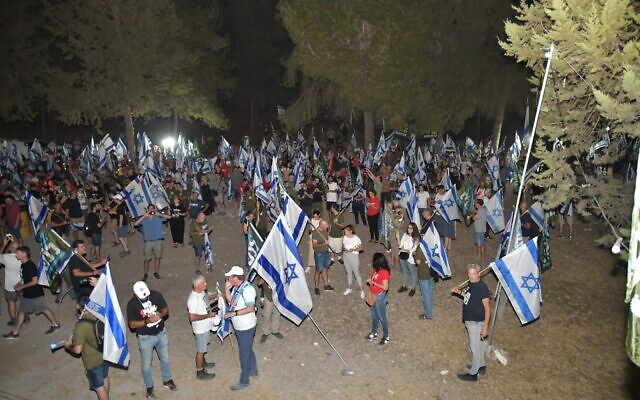 Anti-judicial overhaul protesters gather outside the home of Defense Minister Yoav Gallant in the northern town of Amikam, July 8, 2023. (Courtesy/Amos Gil) Anti-judicial overhaul protesters gather outside the home of Defense Minister Yoav Gallant in the northern town of Amikam, July 8, 2023. (Courtesy/Amos Gil)