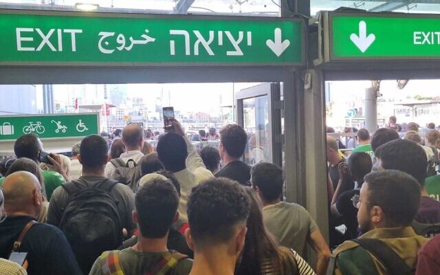 Commuters are seen exiting Hagana Station in Tel Aviv after train service shut down on July 18, 2023 (Courtesy)