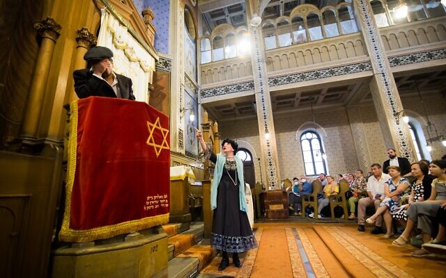 In the Great Synagogue of Sibiu, Romania, actors Alexandru Malaiku and Gabriel Muncuș perform in 'A Secret About Joy,' a play written and produced by Fulbright scholar Sarah Brown (courtesy)