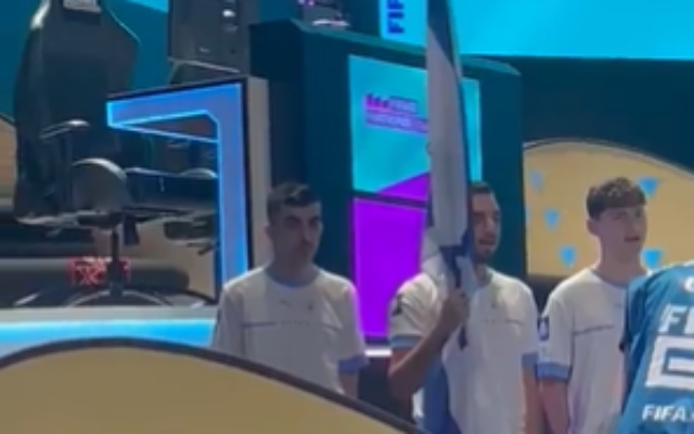 Screen grab from a video of Israel's national team holding the Israeli flag and singing the Israeli national anthem 'Hatikva' at the general rehearsal of the opening ceremony of the 2023 FIFAe World Cup in Riyadh, July 10, 2023 (twitter.com/Kann_news) Screen grab from a video of Israel's national team holding the Israeli flag and singing the Israeli national anthem 'Hatikva' at the general rehearsal of the opening ceremony of the 2023 FIFAe World Cup in Riyadh, July 10, 2023 (twitter.com/Kann_news)
