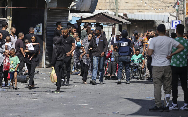 People flee the Jenin refugee camp in the West Bank during an ongoing Israeli military operation on July 4, 2023. (Jaafar Ashtiyeh/AFP)