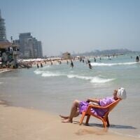 FILE: Israelis and tourists enjoy the beach in Tel Aviv, as a heatwave hits the country, July 17, 2023. (Miriam Alster/FLASH90)