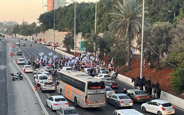 Protesters block the Ayalon Highway at Halacha Interchange in Tel Aviv, July 24, 2023. (Naomi Lanzkron) Protesters block the Ayalon Highway at Halacha Interchange in Tel Aviv, July 24, 2023. (Naomi Lanzkron)