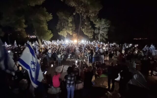 Anti-overhaul activists, who are marching to Jerusalem, gather at Shoresh outside the capital on Friday evening, July 21, 2023. (Aviv Hasidov) Anti-overhaul activists, who are marching to Jerusalem, gather at Shoresh outside the capital on Friday evening, July 21, 2023. (Aviv Hasidov)
