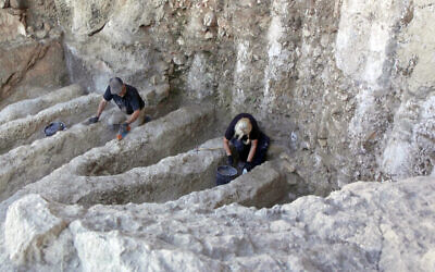 Archaeologists work on mysterious channels found at a unique ancient installation in the City of David, Jerusalem, August 2023. (Emil Aladjem/IAA)