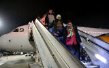 Ukrainian refugees and new immigrants disembark from a plane on their arrival at Israel's Ben Gurion Airport, near Tel Aviv, on December 22, 2022. (Gil Cohen-Magen / AFP)