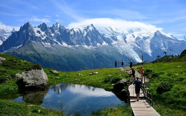 Illustrative: Visitors hike on a trail leading to the Lac Blanc area in the Aiguilles Rouges nature reserve which faces Mont Blanc, above Chamonix, Haute-Savoie, on July 31, 2023. (Emmanuel Dunand/AFP) Illustrative: Visitors hike on a trail leading to the Lac Blanc area in the Aiguilles Rouges nature reserve which faces Mont Blanc, above Chamonix, Haute-Savoie, on July 31, 2023. (Emmanuel Dunand/AFP)