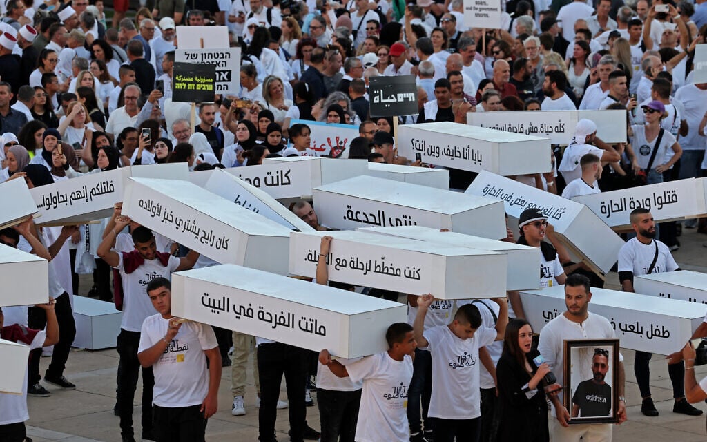 Illustrative: Activists march with symbolic coffins denouncing violent crime in Arab communities on August 6, 2023 in Tel Aviv. (Jack Guez/AFP) Illustrative: Activists march with symbolic coffins denouncing violent crime in Arab communities on August 6, 2023 in Tel Aviv. (Jack Guez/AFP)