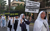 Activists march with placards denouncing the violent crimes in Arab communities on August 6, 2023, in Tel Aviv. (Photo by JACK GUEZ / AFP)