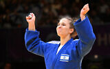 Israel's Inbar Lanir (blue) celebrates her victory over France's Madeleine Malonga after the final of the women's -78kg category of the Judo Masters 2023 in Budapest on August 6, 2023. (ATTILA KISBENEDEK / AFP)