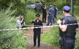 Police officers work at the site where a Ukrainian drone targeting the Russian capital was downed by an air defence system, in western Moscow on August 11, 2023. (Alexander NEMENOV/AFP)