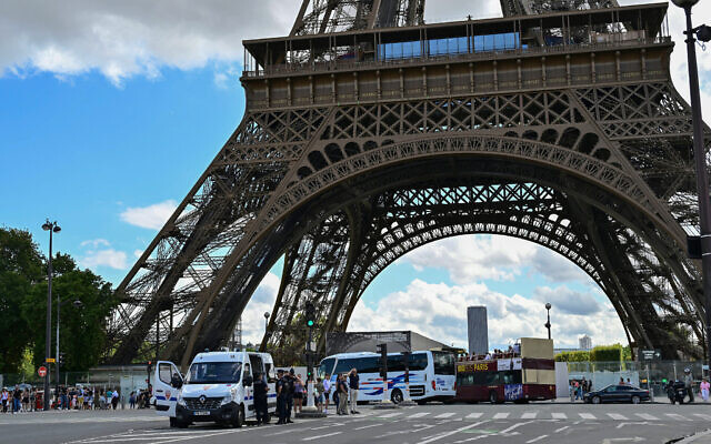 Republican Security Corps (CRS) officers secure the area in central Paris after a security alert prompted the evacuation of three floors of the Eiffel Tower, on August 12, 2023. (Miguel Medina/AFP)