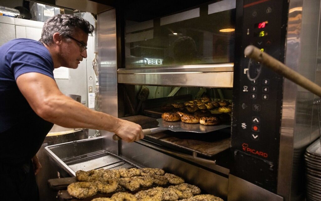 Andrew Martinez, owner of Bo's Bagels, bakes bagels in his store's oven on July 12, 2023 in New York City. (Photo by Yuki IWAMURA / AFP) Andrew Martinez, owner of Bo's Bagels, bakes bagels in his store's oven on July 12, 2023 in New York City. (Photo by Yuki IWAMURA / AFP)