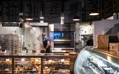 Andrew Martinez, owner of Bo's Bagels, boils bagel dough balls in his store on July 12, 2023 in New York City. (Photo by Yuki IWAMURA / AFP)