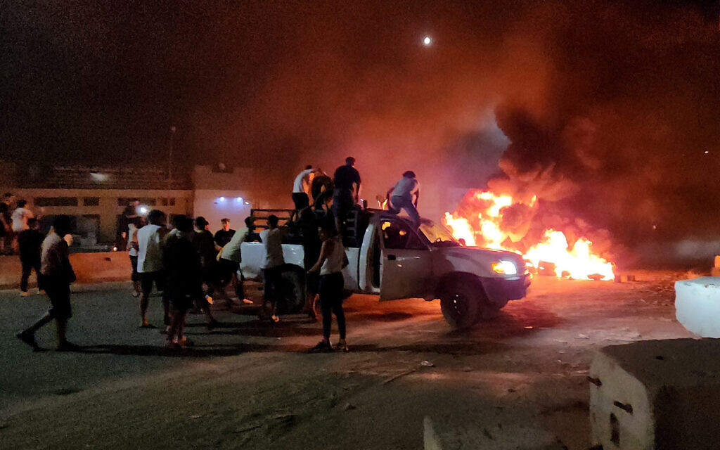 Libyans burn tires as they protest in Tripoli on August 28, 2023, after news broke of a recent meeting between the country's foreign minister and her Israeli counterpart. (Mahmud Turkia/AFP) Libyans burn tires as they protest in Tripoli on August 28, 2023, after news broke of a recent meeting between the country's foreign minister and her Israeli counterpart. (Mahmud Turkia/AFP)