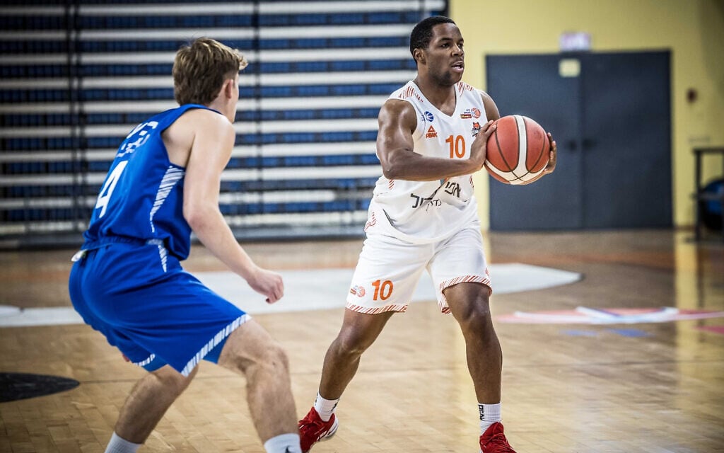 Jared Armstrong, right, playing professional basketball in Israel. (Courtesy of Armstrong via JTA) Jared Armstrong, right, playing professional basketball in Israel. (Courtesy of Armstrong via JTA)