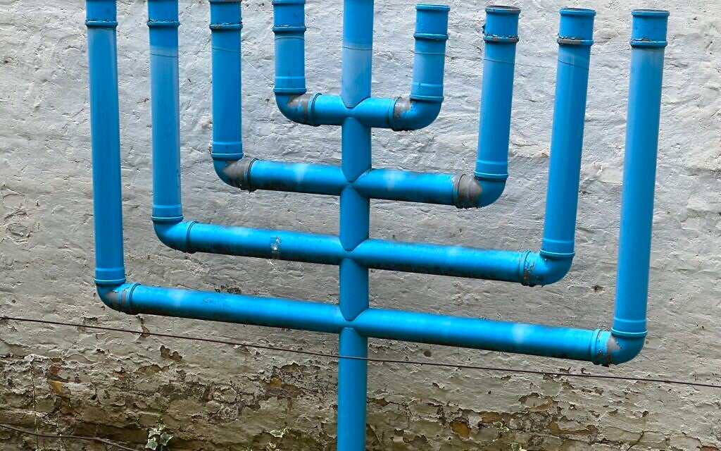 A makeshift nine-branched menorah contructed from recycled water pipes is seen outside the synagogue in Novi Sad, Serbia. (Larry Luxner/ JTA)