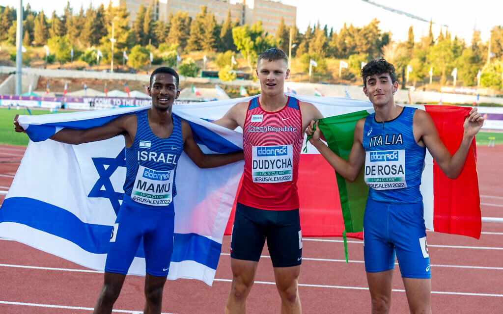 Mamu Noam of Israel, Jakub Dudycha of the Czech Republic and Davide De Rosa of Italy celebrate after the men's 800 meter event during the 2022 European Athletics U18 Championships at Givat-Ram Stadium in Jerusalem, July 7, 2022. (Jurij Kodrun/Getty Images for European Athletics via JTA) Mamu Noam of Israel, Jakub Dudycha of the Czech Republic and Davide De Rosa of Italy celebrate after the men's 800 meter event during the 2022 European Athletics U18 Championships at Givat-Ram Stadium in Jerusalem, July 7, 2022. (Jurij Kodrun/Getty Images for European Athletics via JTA)