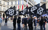 Demonstrators hold flags during a demonstration called by fundamentalist Catholic organization Civitas on May 8, 2016 in Paris. (FRANCOIS GUILLOT / AFP)