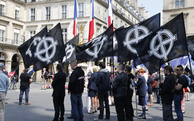 Demonstrators hold flags during a demonstration called by fundamentalist Catholic organization Civitas on May 8, 2016 in Paris. (FRANCOIS GUILLOT / AFP)