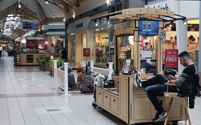 Illustrative: In this photo taken Wednesday, May 4, 2016, a worker sits at a kiosk on a quiet evening at Steeplegate Mall in Concorde, New Hampshire (AP Photo/Jim Cole) Illustrative: In this photo taken Wednesday, May 4, 2016, a worker sits at a kiosk on a quiet evening at Steeplegate Mall in Concorde, New Hampshire (AP Photo/Jim Cole)