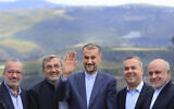 Iranian Foreign Minister Hossein Amir-Abdollahian, center, waves as he stands with Hezbollah members and lawmakers  in southern Lebanon near the Israel border on April 28, 2023. (AP/Mohammed Zaatari)