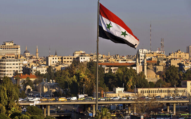 Illustrative: A Syrian national flag waves as vehicles move on a bridge during rush hour, in Damascus, Syria, on Feb. 28, 2016. (Hassan Ammar/AP) Illustrative: A Syrian national flag waves as vehicles move on a bridge during rush hour, in Damascus, Syria, on Feb. 28, 2016. (Hassan Ammar/AP)