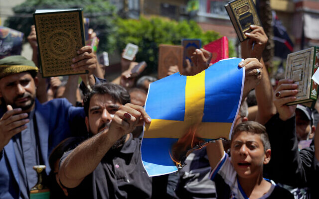 Illustrative: Hezbollah supporters chant slogans as they burn representations of the Swedish flag during a rally in the southern Beirut suburb of Dahiyeh, Lebanon, July 21, 2023. (AP Photo/Bilal Hussein) Illustrative: Hezbollah supporters chant slogans as they burn representations of the Swedish flag during a rally in the southern Beirut suburb of Dahiyeh, Lebanon, July 21, 2023. (AP Photo/Bilal Hussein)