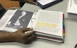Pastor Charlie Grant shows a binder of information he has about Rosenwald Schools and Julius Rosenwald, gathered as he worked to restore a building in Hampton County on Tuesday, July 11, 2023, in Hampton, South Carolina. (AP Photo/Jeffrey Collins)