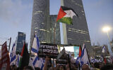 Demonstrators wave Israeli and Palestinian flags during a protest against plans by Prime Minister Benjamin Netanyahu's government to overhaul the judicial system, in Tel Aviv, Israel, Saturday, July 22, 2023. The black banner (center) reads: 'There is no democracy with occupation'. (AP Photo/Mahmoud Illean, File)
