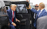 Former US president Donald Trump exits his vehicle to speak with reporters before boarding his plane at Ronald Reagan Washington National Airport, in Arlington, Virginia, August 3, 2023. (AP/Alex Brandon)