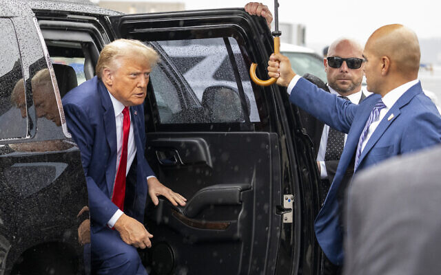 Former US president Donald Trump exits his vehicle to speak with reporters before boarding his plane at Ronald Reagan Washington National Airport, in Arlington, Virginia, August 3, 2023. (AP/Alex Brandon) Former US president Donald Trump exits his vehicle to speak with reporters before boarding his plane at Ronald Reagan Washington National Airport, in Arlington, Virginia, August 3, 2023. (AP/Alex Brandon)