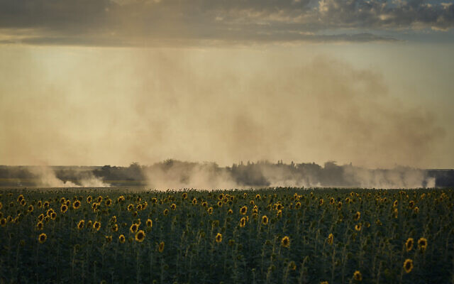 A smoke rises over sunflowers field on the frontline in Donetsk region, Ukraine, Wednesday, Aug. 9, 2023. (AP Photo/Libkos) A smoke rises over sunflowers field on the frontline in Donetsk region, Ukraine, Wednesday, Aug. 9, 2023. (AP Photo/Libkos)