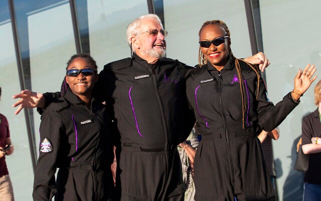 Space tourists, from left, Anastatia Mayers, Jon Goodwin and Keisha Schahaff pose for photos before boarding their Virgin Galactic flight at Spaceport America, near Truth or Consequences, NM, Thursday, August 10, 2023. (AP Photo/Andrés Leighton)