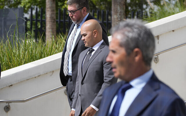 Walt Nauta, center, valet to former US president Donald Trump, his attorney Stanley Woodward, rear, and Carlos De Oliveira, foreground, the property manager of Trump's Mar-a-Lago estate, leave the Alto Lee Adams Sr. US Courthouse, Thursday, August 10, 2023, in Fort Pierce, Fla. (AP Photo/Wilfredo Lee) Walt Nauta, center, valet to former US president Donald Trump, his attorney Stanley Woodward, rear, and Carlos De Oliveira, foreground, the property manager of Trump's Mar-a-Lago estate, leave the Alto Lee Adams Sr. US Courthouse, Thursday, August 10, 2023, in Fort Pierce, Fla. (AP Photo/Wilfredo Lee)