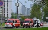 Police and emergency vehicles parked at the side of the wreckage of the drone fell near the Karamyshevskaya embankment to the after a reported drone attack in Moscow, Russia, on Friday, August 11, 2023. (AP Photo)