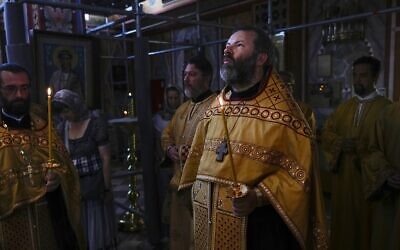 The Rev. Andrei Kordochkin conducts a religion service at the Russian Cathedral of Saint Mary Magdalene in Madrid, Spain, Saturday, July 15, 2023. In February, Moscow's Patriarch Kirill suspended Kordochkin, a priest at an Orthodox church in Madrid, after he condemned the Kremlin's decision to send troops to Ukraine. (AP Photo/Paul White)