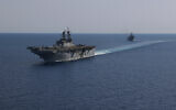 The amphibious assault ship USS Bataan, front, and the landing ship USS Carter Hall, back travel through the Red Sea, August 8, 2023. (Mass Communication Specialist 3rd Class Riley Gasdia/US Navy, via AP)