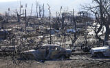 Destroyed homes and cars are shown, Sunday, Aug. 13, 2023, in Lahaina, Hawaii. (AP Photo/Rick Bowmer)