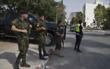 Palestinian security forces stationed at a main junction in the West Bank city of Jenin, Sunday, Aug. 13, 2023. (AP/Nasser Nasser)