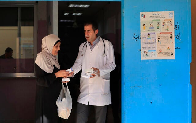 File: A Palestinian woman receives medicine from a doctor at a clinic run by the agency for Palestinian refugees, or UNRWA, in the Ein el-Hilweh refugee camp in the southern port city of Sidon, Lebanon, June 20, 2023. (AP Photo/Mohammed Zaatari) File: A Palestinian woman receives medicine from a doctor at a clinic run by the agency for Palestinian refugees, or UNRWA, in the Ein el-Hilweh refugee camp in the southern port city of Sidon, Lebanon, June 20, 2023. (AP Photo/Mohammed Zaatari)