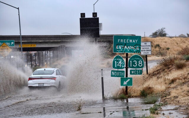 A vehicle drives through a flooded freeway entrance in Palmdale, Calif. as a tropical storm moves into the area on Sunday, Aug. 20, 2023. (AP Photo/Richard Vogel) A vehicle drives through a flooded freeway entrance in Palmdale, Calif. as a tropical storm moves into the area on Sunday, Aug. 20, 2023. (AP Photo/Richard Vogel)