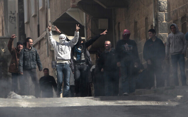 Illustrative: Anti-Syrian government protesters flash Victory signs as they protest in the southern city of Daraa, Syria, March 23, 2011.  (AP Photo/Hussein Malla)